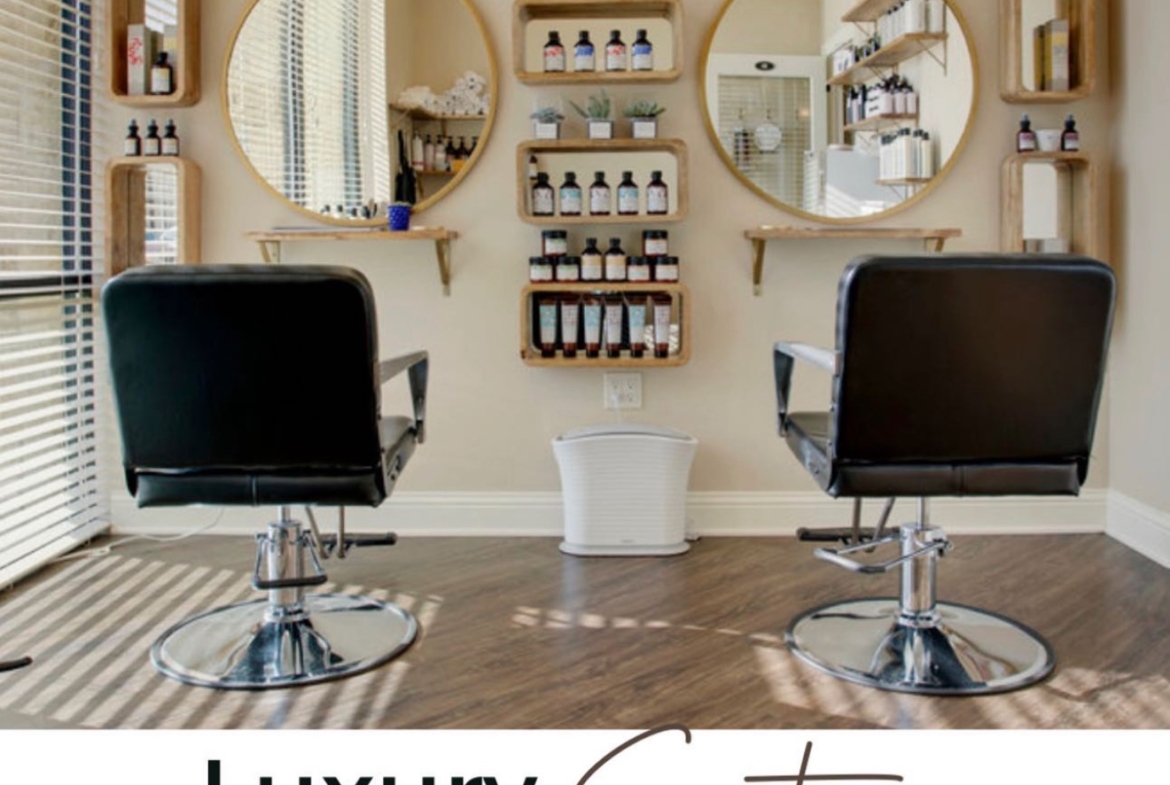 Premium salon chairs and custom decor create a luxury hair salon experience.